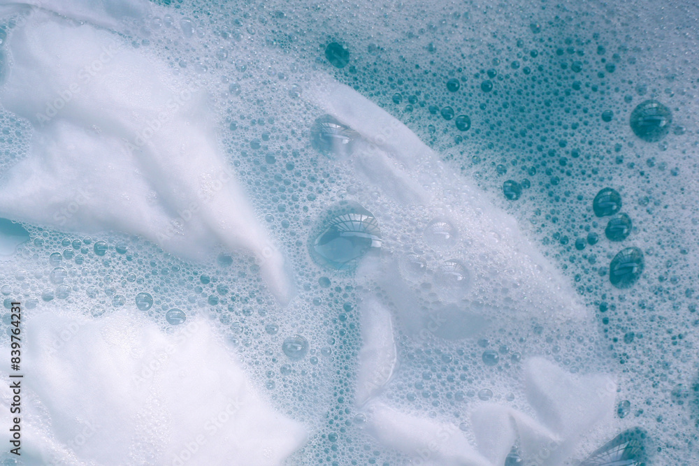 Naklejka premium White cloth soaked in powder detergent water dissolution, washing cloth. Laundry concept
