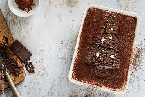 Christmas dessert with chopped dark chocolate, festive tiramisu idea overhead view on table photo