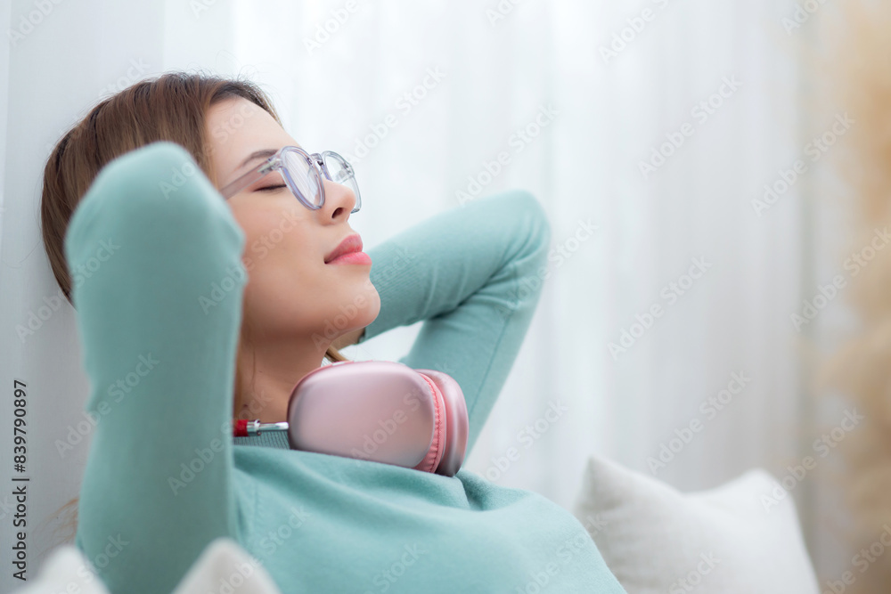 Young asian woman wearing glasses sitting on sofa for relax and leisure in living room at home, woman with cozy and resting in house, lifestyle and domestic life concept. Young asian woman wearing glasses sitting on sofa for relax and leisure in living room at home, woman with cozy and resting in house, lifestyle and domestic life concept.