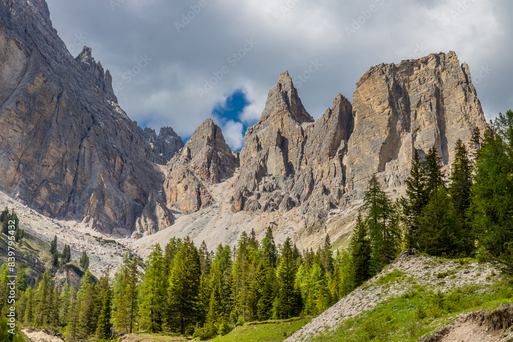 Obraz premium Dolomites mountains, Alpi Dolomiti beautiful scenic landscape in summer. Italian Alps mountain summits and rocky peaks above green valley alpine scene