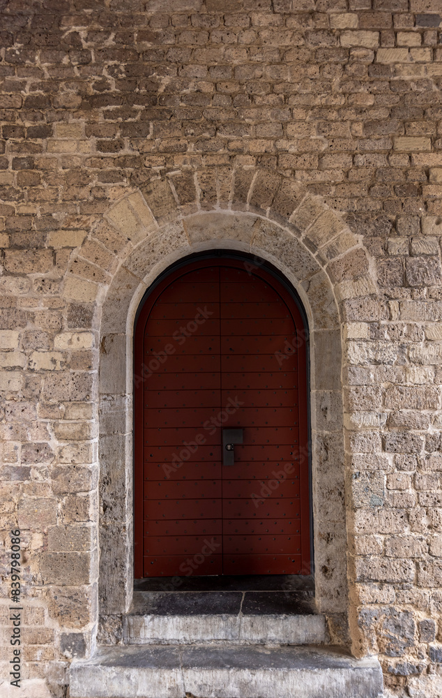 red door with merallic inserts in an old stone castle
red door with merallic inserts in an old stone castle