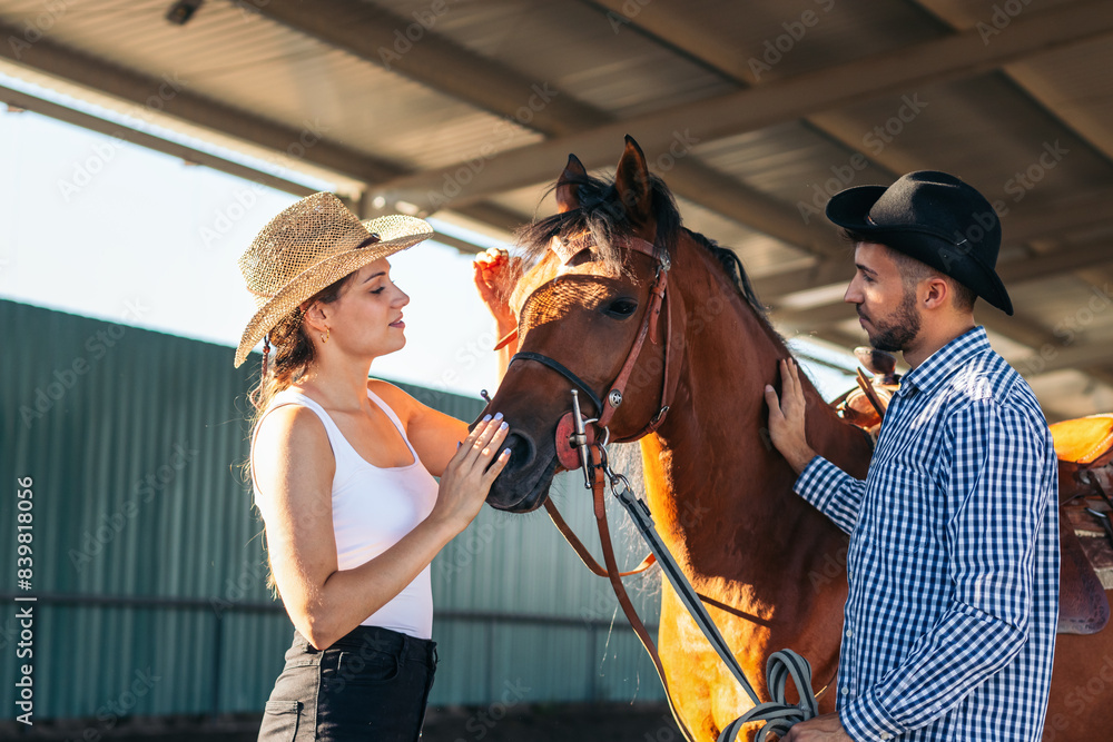 Friends walking with a horse in an equestrian center Friends walking with a horse in an equestrian center