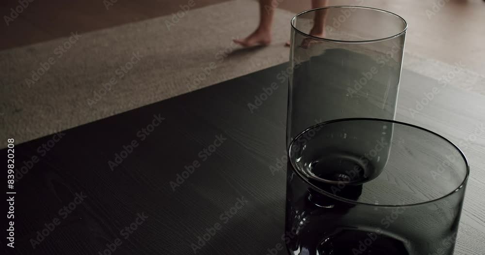 A serene indoor scene featuring two oversized glass vases and the bare feet of a woman, positioned on a soft carpet. Artistic Image of Two Large Glass Vases and Female Feet on Carpet A serene indoor scene featuring two oversized glass vases and the bare feet of a woman, positioned on a soft carpet. Artistic Image of Two Large Glass Vases and Female Feet on Carpet