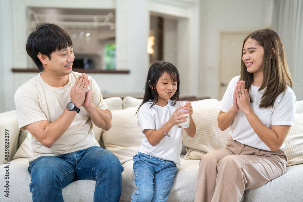 Portrait of enjoy happy love asian healthy family father and mother with asian girl smiling and having protein breakfast drinking hold glasses of milk, nutrition, calcium, vitamin at home Portrait of enjoy happy love asian healthy family father and mother with asian girl smiling and having protein breakfast drinking hold glasses of milk, nutrition, calcium, vitamin at home