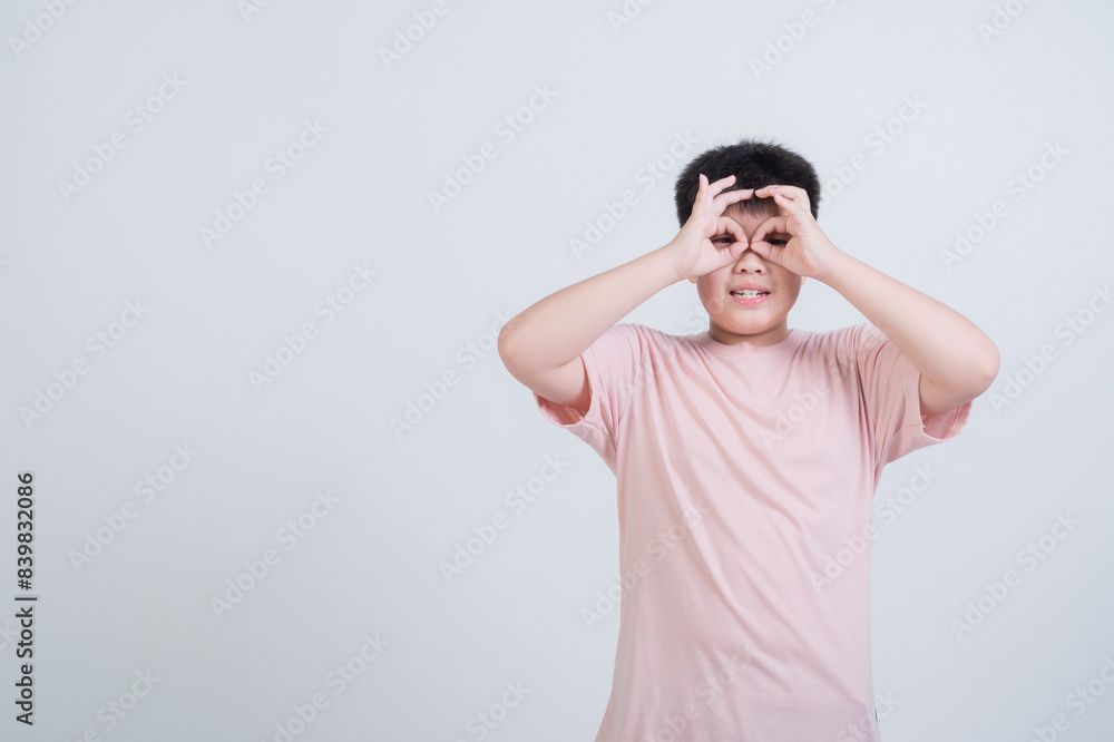 boy on white background, child holding hand to eye boy on white background, child holding hand to eye