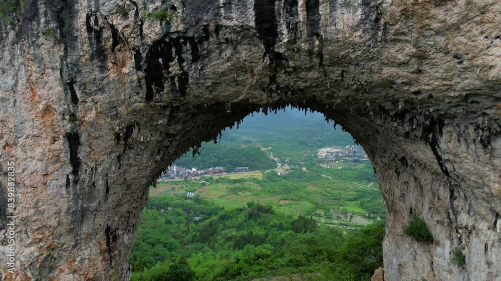 Drone approaching natural arch of Moon Hill with stalactites in Yangshuo, China Drone approaching natural arch of Moon Hill with stalactites in Yangshuo, China