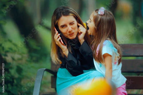 Child Yelling While Mom Tries to Speak on the Phone. Little kid interrupting her mother while trying to have a conversation
