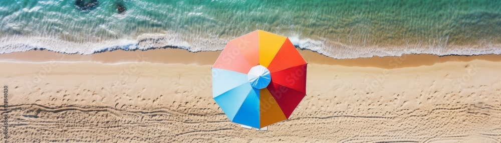 A colorful umbrella is on the beach, with people in the background. Scene is cheerful and lively, as the umbrella and people are enjoying their time at the beach A colorful umbrella is on the beach, with people in the background. Scene is cheerful and lively, as the umbrella and people are enjoying their time at the beach
