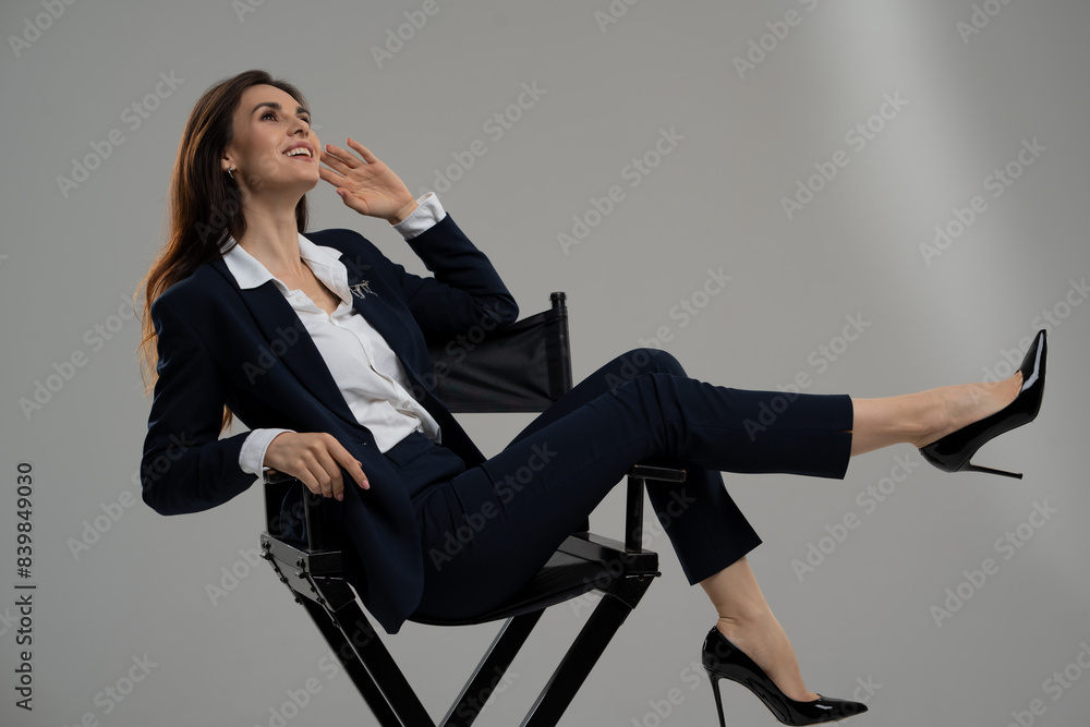 A professional woman sitting comfortably in a directors chair A professional woman sitting comfortably in a directors chair