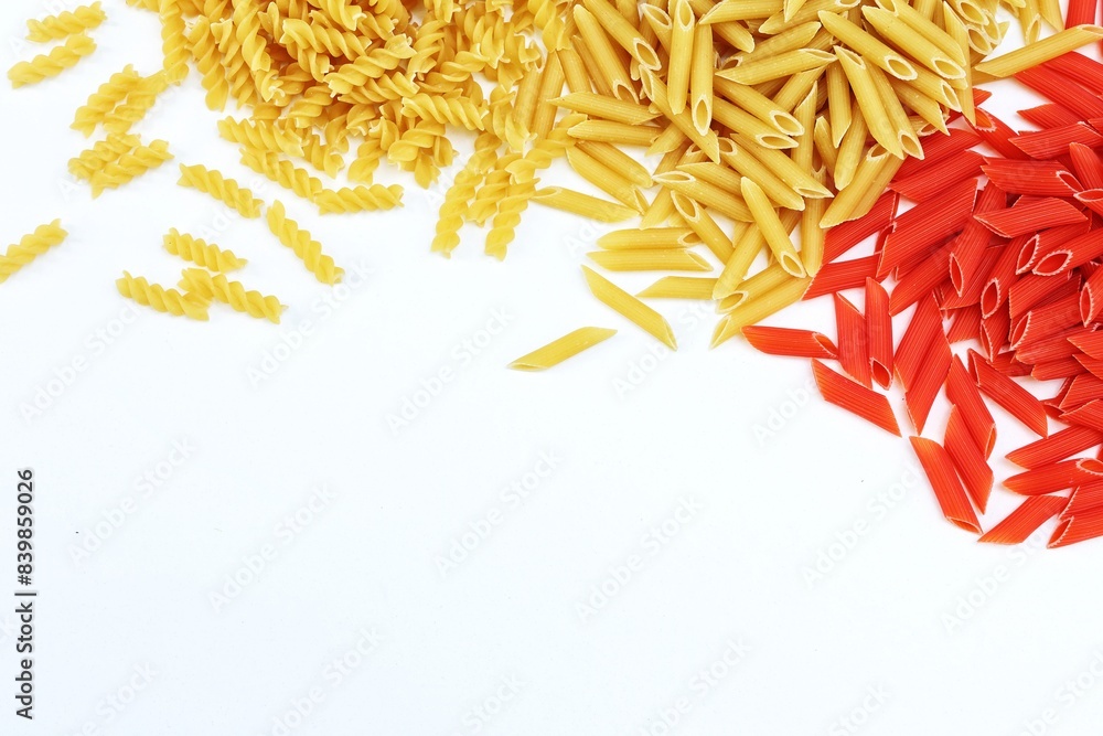 Fototapeta premium Macaroni red and yellow, on a white table, free space, place for text, top view, background