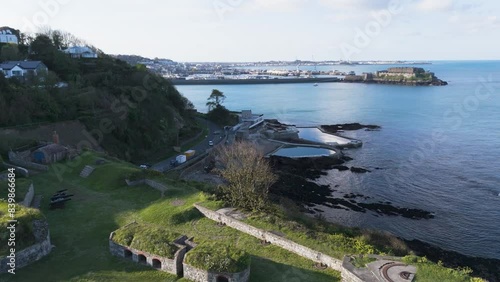 Drone footage across  the sea bathing pools and Havelet Bay Guernsey from Clarence Battery to Castle Cornet and St Peter Port on bright sunny day photo