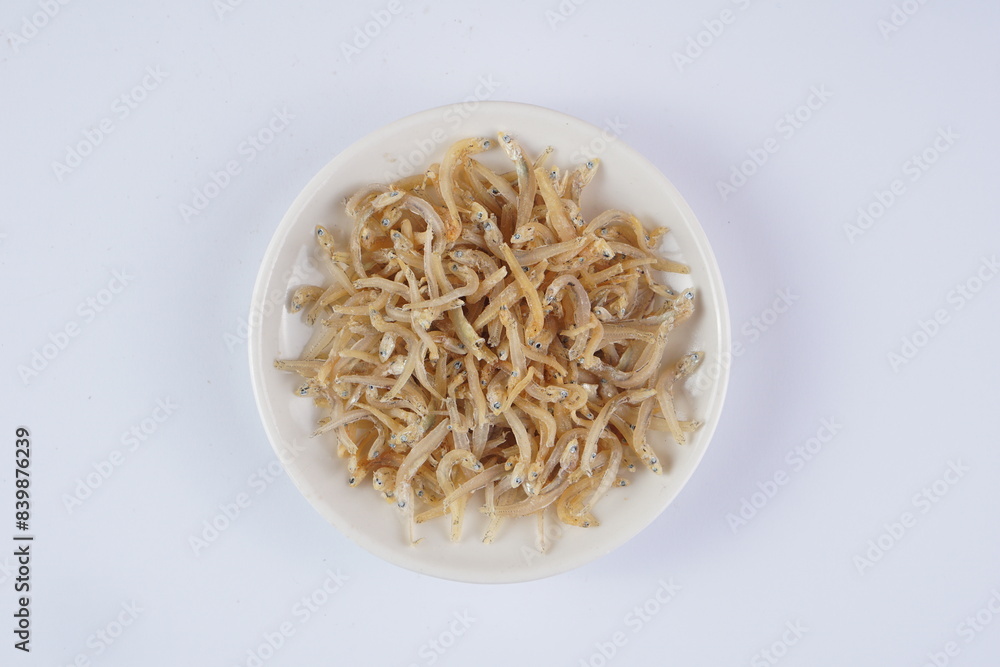 raw salted anchovies on a white background with studio lighting, in Indonesia is called raw salted anchovies on a white background with studio lighting, in Indonesia is called