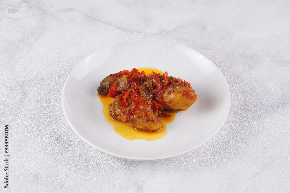 Indonesian typical balado fried chicken on a white plate on a white background with studio lighting Indonesian typical balado fried chicken on a white plate on a white background with studio lighting