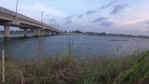 Wallpaper Mural Footage 4K of green grass blowing by the wind in the Depok lagoon under Kretek 2 Bridge, Bantul, Yogyakarta, Indonesia at dusk Torontodigital.ca