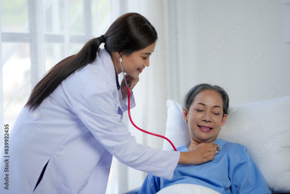 Doctor examining patient with stethoscope in hospital bed. Medical care and healthcare concept in a clinical setting. Doctor examining patient with stethoscope in hospital bed. Medical care and healthcare concept in a clinical setting.