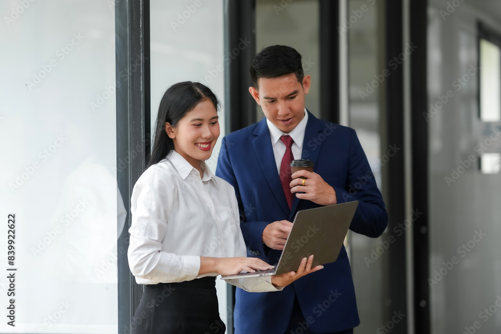 Professional business meeting between a man and a woman, discussing ideas and collaborating over a laptop in modern office setting. Professional business meeting between a man and a woman, discussing ideas and collaborating over a laptop in modern office setting.