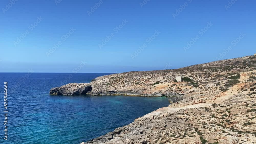 Comino Island,Malta, Comino coast close to Santa Marija tower, It-Torri ta' Santa Marija, revealing mediterranean sea with fishing farm rings , and boats sailing close to Malta island coast. High Comino Island,Malta, Comino coast close to Santa Marija tower, It-Torri ta' Santa Marija, revealing mediterranean sea with fishing farm rings , and boats sailing close to Malta island coast. High