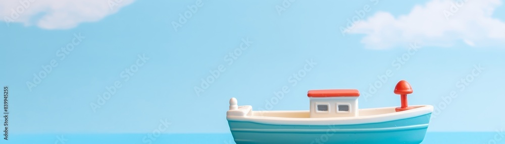 Naklejka premium A small red boat is sitting on a blue background