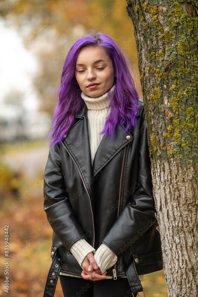 Portrait of a young beautiful girl with purple hair in the autumn city. Portrait of a young beautiful girl with purple hair in the autumn city.