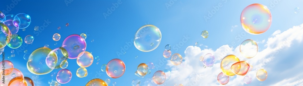 A bunch of colorful bubbles floating in the sky. The bubbles are of different colors and sizes, creating a vibrant and playful atmosphere. The blue sky serves as a backdrop, emphasizing the bright A bunch of colorful bubbles floating in the sky. The bubbles are of different colors and sizes, creating a vibrant and playful atmosphere. The blue sky serves as a backdrop, emphasizing the bright