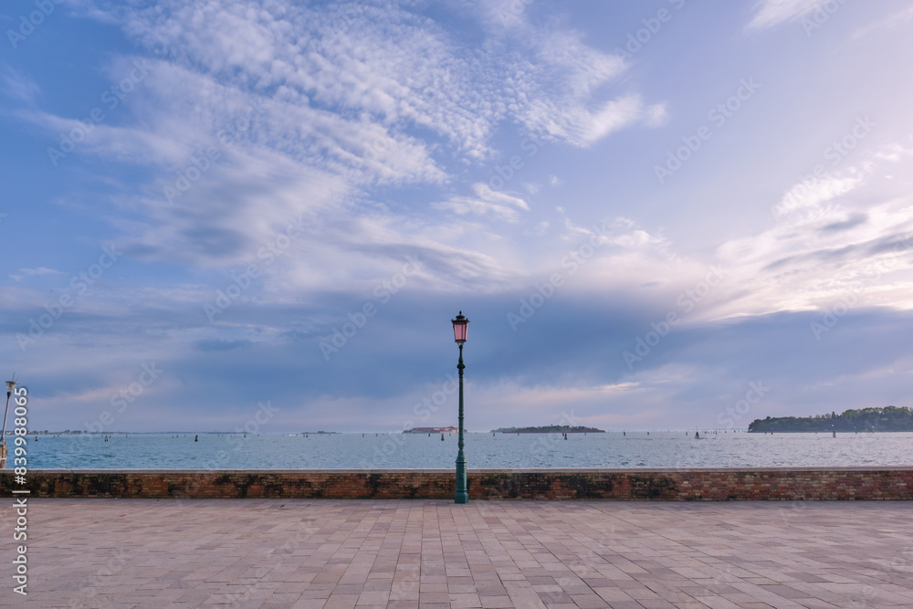 Seaside in Venice, street lamp. A lampstand on the promenade along the water. Seaside in Venice, street lamp. A lampstand on the promenade along the water.