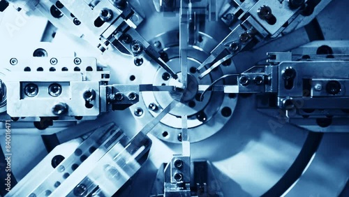 Close up of metal spring manufacturing machine at work