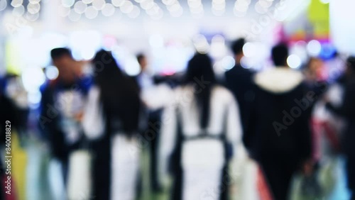 Large group of people walking in exhibition hall