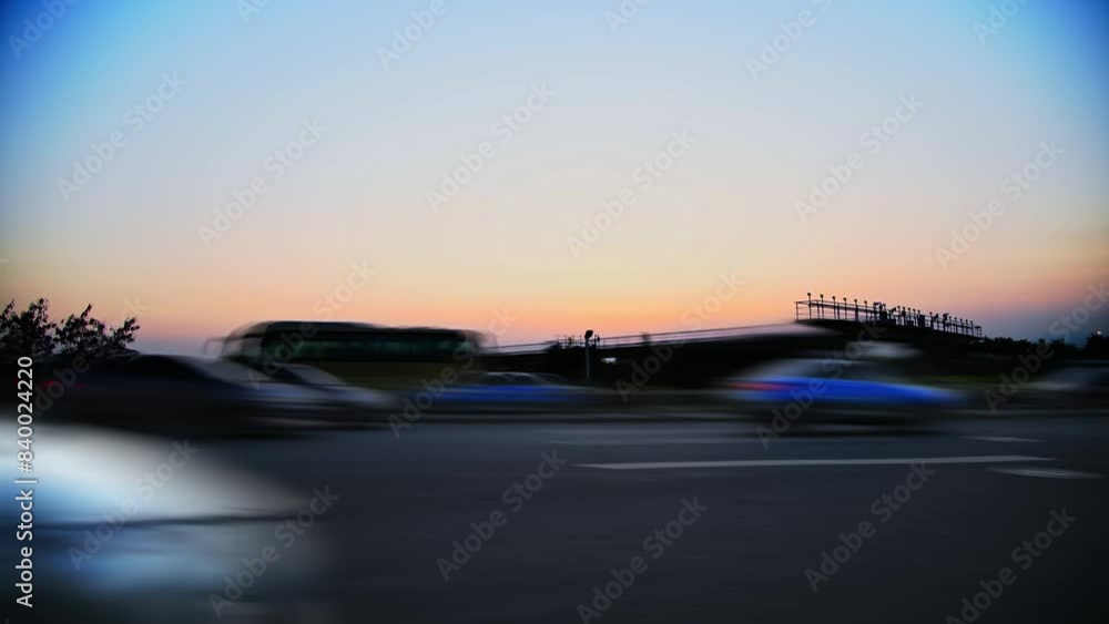 The airplane is landing in the evening with traffic on road The airplane is landing in the evening with traffic on road