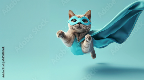 superhero cat with a blue cloak and mask flying, isolated on a light cyan background. That funny animal in an action pose © pikshine