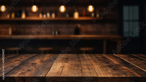 Empty dark wooden table top on blurred bar or restaurant background with warm lighting. Banner with copy space. Template showcase scene for display, montage, advertising product.