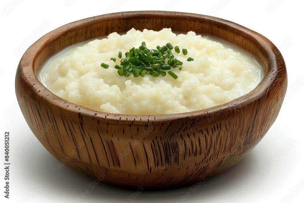 Creamy rice pudding in a wooden bowl, garnished with fresh herbs, creating a comforting and indulgent dessert Creamy rice pudding in a wooden bowl, garnished with fresh herbs, creating a comforting and indulgent dessert
