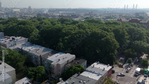 higher view of McGolrick Park in Greenpoint Brooklyn flying back past church