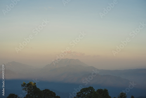 travel and people activity concept with twilight sky before sunset with layer of mountain