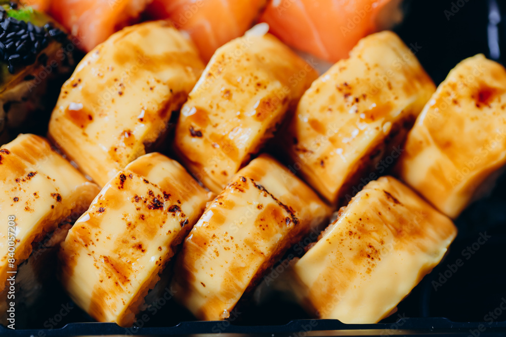Delicious fresh and juicy roll prepared on the grill with salmon. With cream cheese, avocado, wasabi and ginger Delicious fresh and juicy roll prepared on the grill with salmon. With cream cheese, avocado, wasabi and ginger