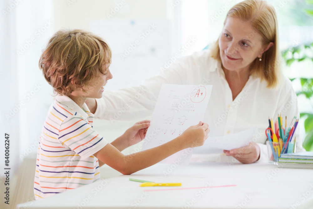 Child holding school test with excellent A grade. Child holding school test with excellent A grade.