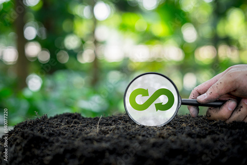 Green renewable energy for future growth and environmental sustainability and reduce future pollution, a magnifying glass on the floor with an infinity symbol