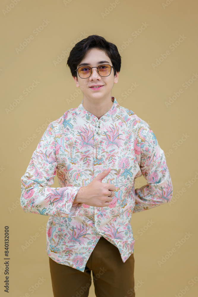 Fashion portrait of the young handsome guy posing casually wearing a Modern Traditional Lanna Dress Shirt decorative motifs. Man who upholds local values. Fashion portrait of the young handsome guy posing casually wearing a Modern Traditional Lanna Dress Shirt decorative motifs. Man who upholds local values.