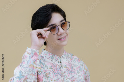 Fashion portrait of the young handsome guy posing casually wearing a Modern Traditional Lanna Dress Shirt decorative motifs. Man who upholds local values.