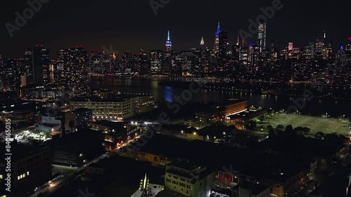 Wallpaper Mural An aerial time lapse at night over Long Island City, Queens with the Eastside of New York City in the background. The drone camera dolly in towards the East River. Torontodigital.ca