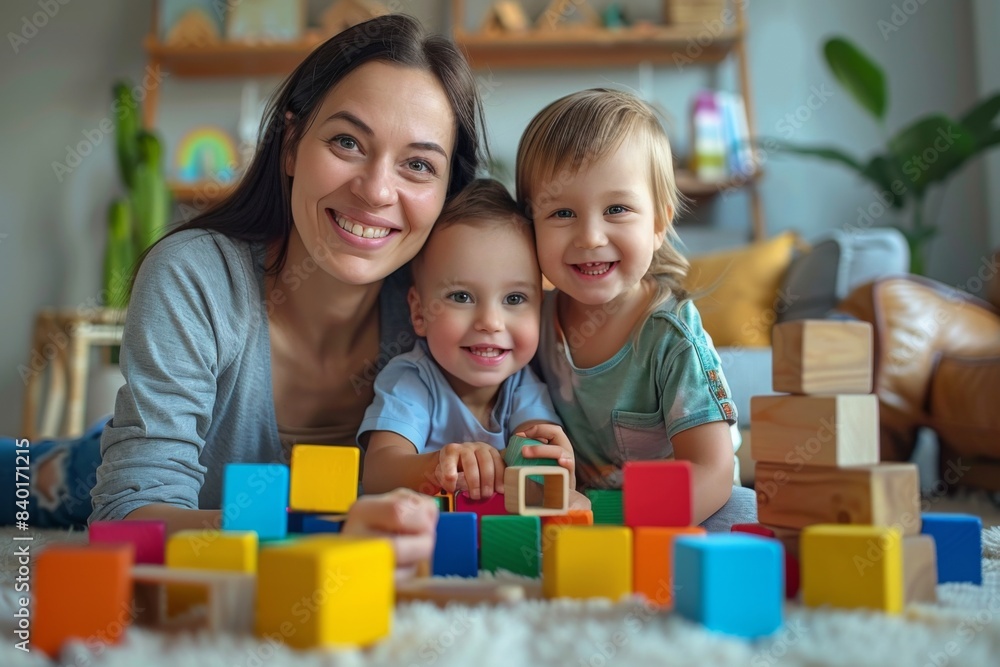 Two kids building with blocks on the ground