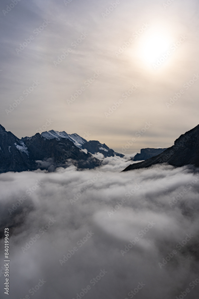 View of Swiss Alps over clouds on a bright sunny day