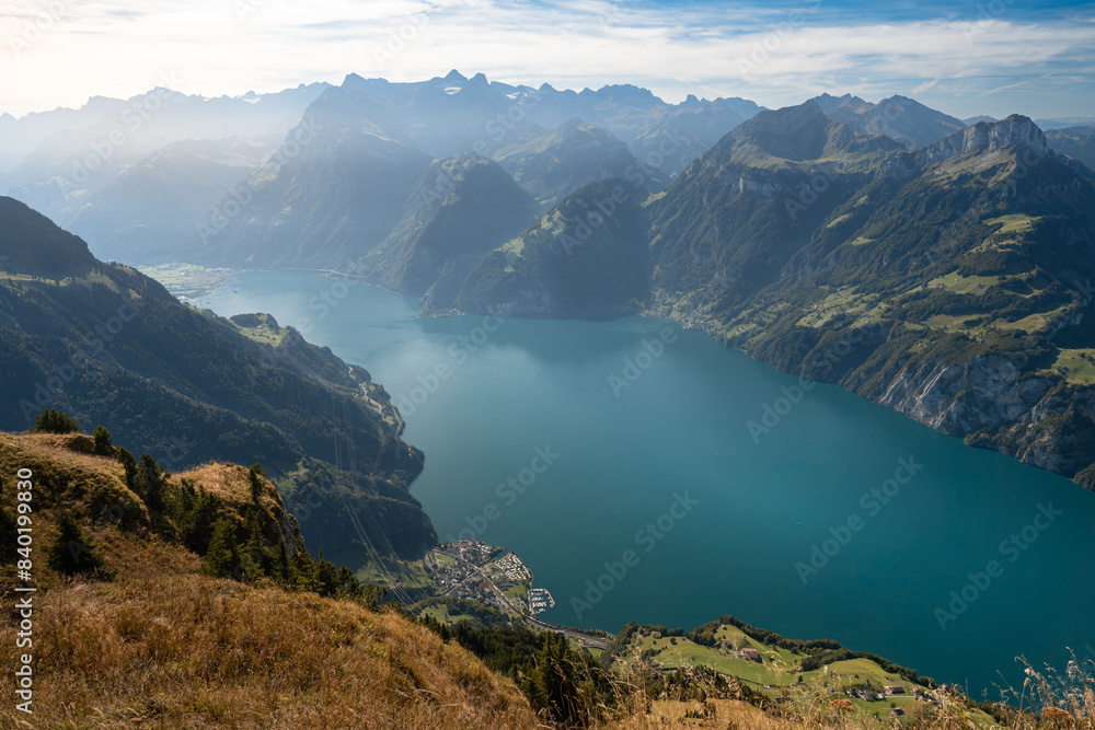 Lake in a valley seen from Fronalpstock summit in Switzerland. Swiss Alps iconic view