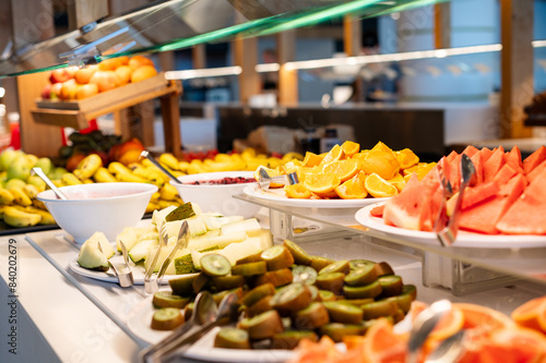 A fruit display with a variety of fruits including bananas, oranges, and watermelon. The presentation is colorful and inviting, making it an appealing choice for a healthy snack or dessert