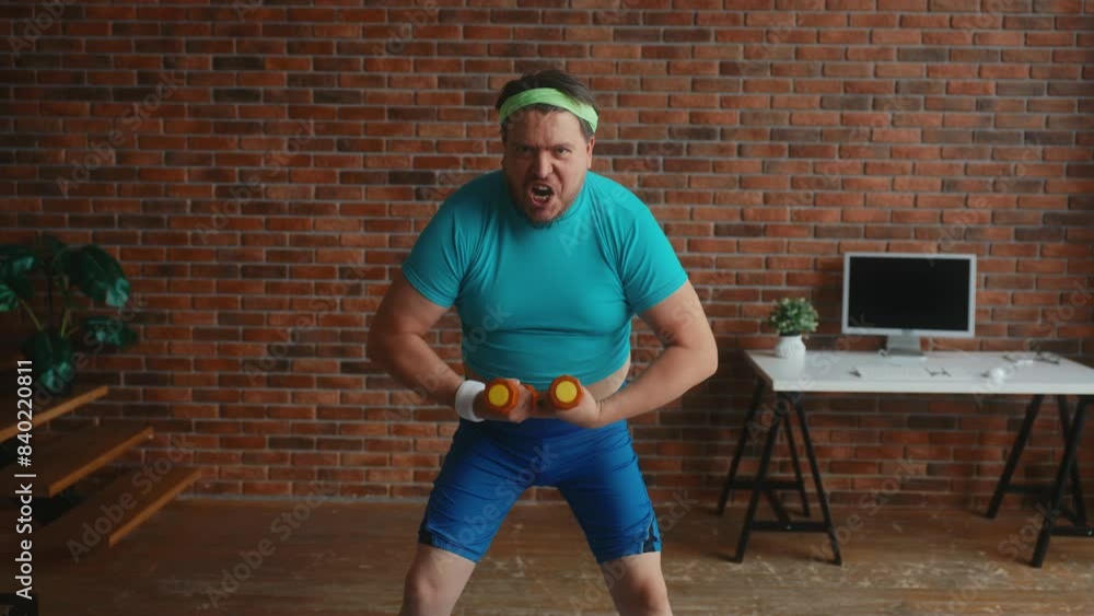 Funny man with obese figure doing workout with dumbbells Funny man with obese figure doing workout with dumbbells