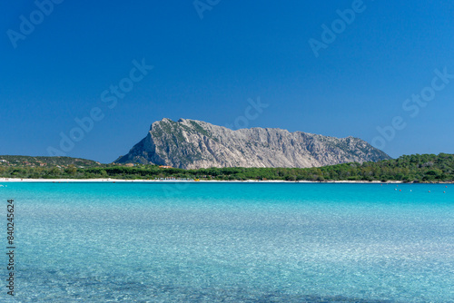 lu Impostu beach with crystal clear water and white sand, with Tavolara Island in the background, San Teodoro, Sardinia, Italy