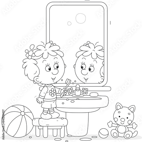 Funny little girl brushing her teeth at a mirror and washbasin in a bathroom with toys, black and white vector cartoon illustration for a coloring book
