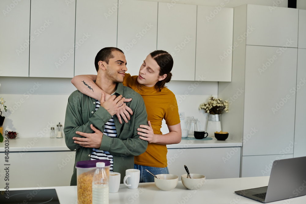 A young gay couple embraces in a modern kitchen, sharing a loving moment as they enjoy their morning together. A young gay couple embraces in a modern kitchen, sharing a loving moment as they enjoy their morning together.