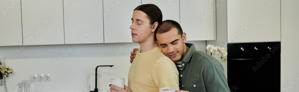 Two young men share a moment of intimacy in their modern apartment kitchen. Two young men share a moment of intimacy in their modern apartment kitchen.