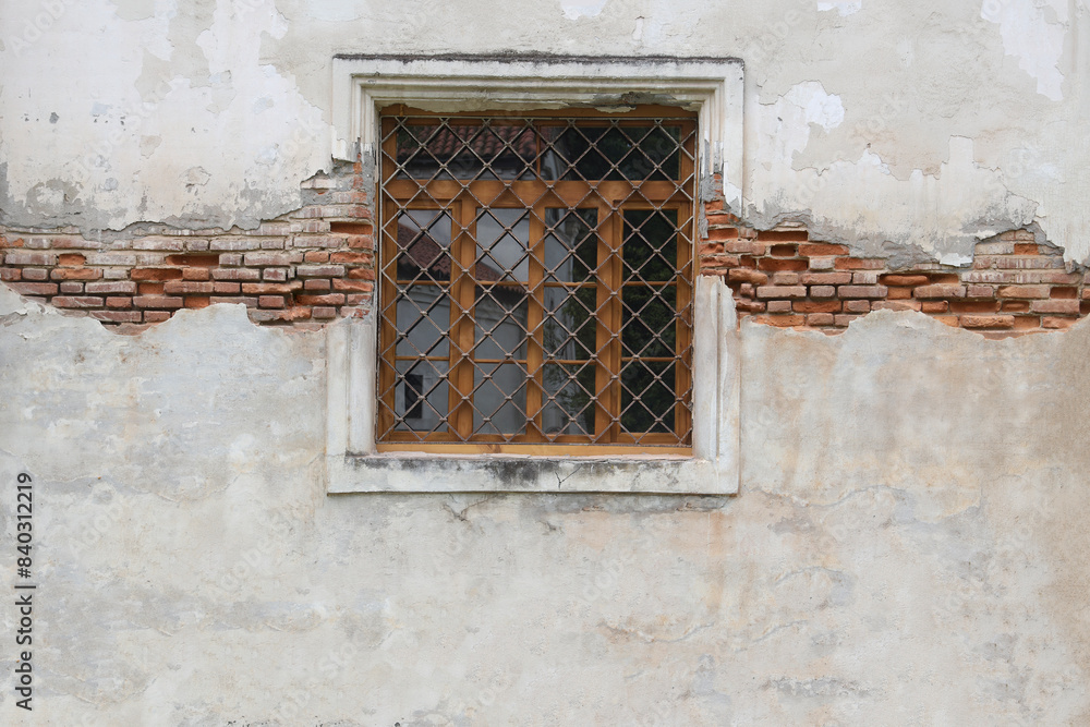 square window with lattice bars in the white brick wall of the fortress. Old rough brick wall with concrete and with window with bars. Dadiani Palace, Georgia, Zugdidi. square window with lattice bars in the white brick wall of the fortress. Old rough brick wall with concrete and with window with bars. Dadiani Palace, Georgia, Zugdidi.