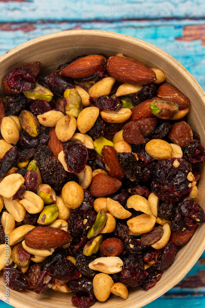 Mix of nuts and dried fruits in a wooden bowl on a wooden background, student mix of nuts and dried fruits, healthy snack, nuts and dried fruits Mix of nuts and dried fruits in a wooden bowl on a wooden background, student mix of nuts and dried fruits, healthy snack, nuts and dried fruits